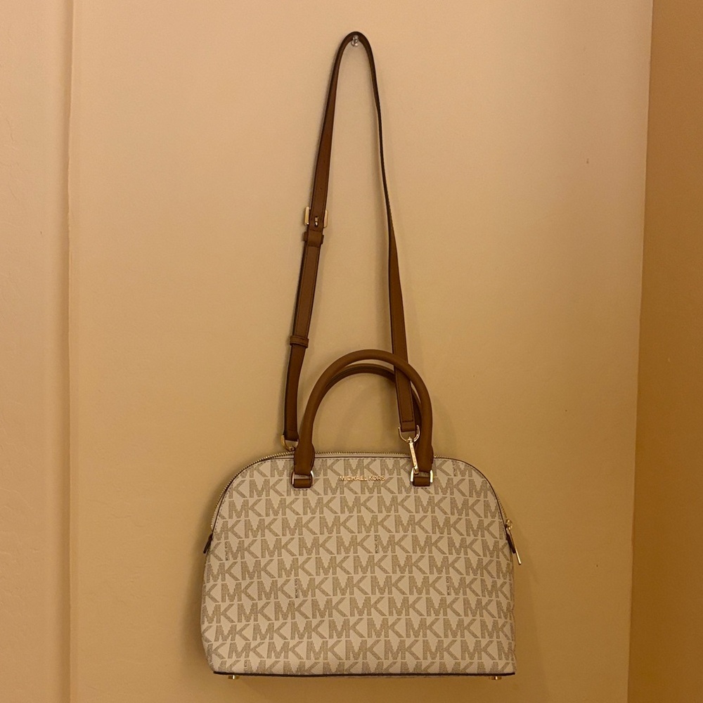 Tan Micheal Kors crossbody with gold hardware and brown handle